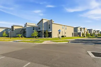 an empty street in front of a row of houses at 4350 Storey Lake 17 guests near parks poolspa in Kissimmee