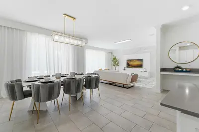 a dining room with a table and chairs and a couch at 4350 Storey Lake 17 guests near parks poolspa in Kissimmee