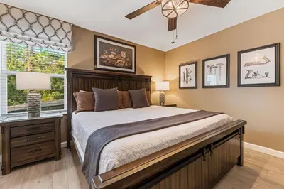 a bedroom with a large bed and a window at New Storey Lake Dream Family Escape in Kissimmee