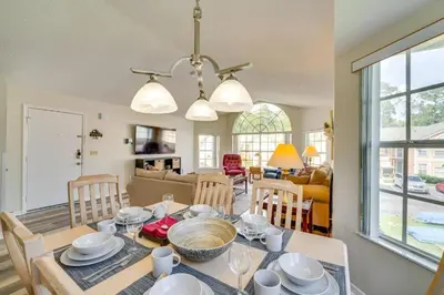 a dining room and living room with a table and chairs at DisneyCondo 10 PP Mr Fredricksen House in Kissimmee