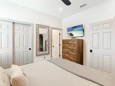 a bedroom with a bed and a mirror and a dresser at 4BR Luxury Villa, Pool & GameRoom in Windsor Hills in Orlando