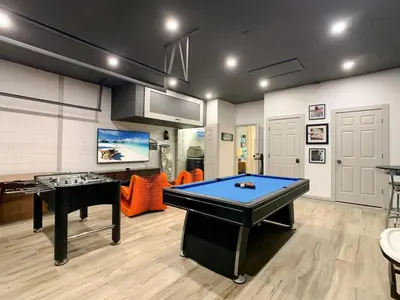 a room with a pool table and a tv at 4BR Luxury Villa, Pool & GameRoom in Windsor Hills in Orlando