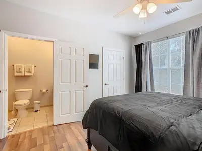 a bedroom with a bed and a toilet and a window at Themed 2BR Condo Near Disney + Resort Amenities in Kissimmee