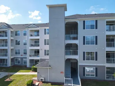 a large apartment building with balconies at Themed 2BR Condo Near Disney + Resort Amenities in Kissimmee
