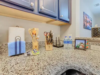 a kitchen counter with some items on top of it at Themed 2BR Condo Near Disney + Resort Amenities in Kissimmee