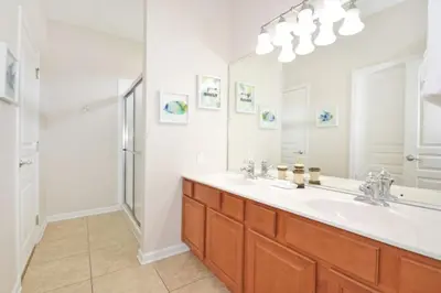 a bathroom with a sink and a mirror at Ohana Haven home in Orlando