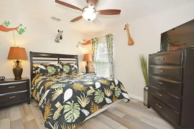 a bedroom with a bed and a ceiling fan at Ohana Haven home in Orlando