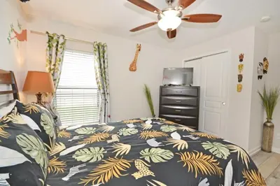 a bedroom with a bed and a ceiling fan at Ohana Haven home in Orlando