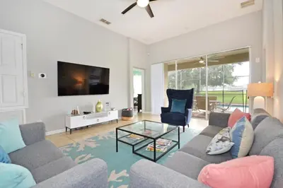a living room with a couch and a tv at Ohana Haven home in Orlando