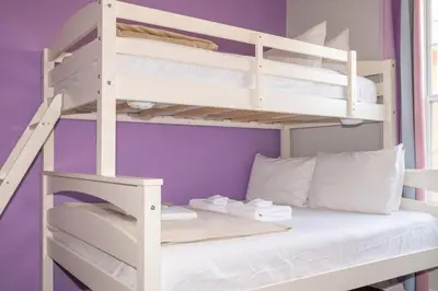 a bunk bed with white bunk beds in a room at Paradise Palms - Spacious house and swimming pool in Kissimmee