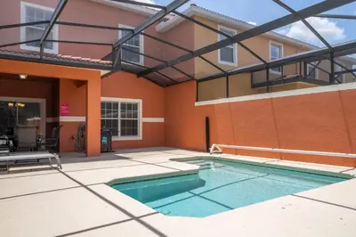 a swimming pool in front of a building at Paradise Palms - Spacious house and swimming pool in Kissimmee