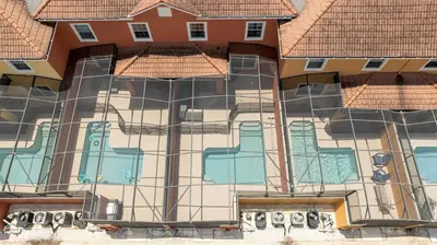 a building with a painting on the side of it at Paradise Palms - Spacious house and swimming pool in Kissimmee