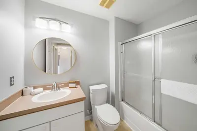 a bathroom with a toilet sink and a shower at 4704 Flagler Beach Way in Kissimmee