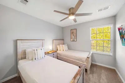 a bedroom with two beds and a ceiling fan at 4704 Flagler Beach Way in Kissimmee