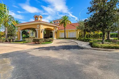 a large yellow house with a road in front of it at 4704 Flagler Beach Way in Kissimmee