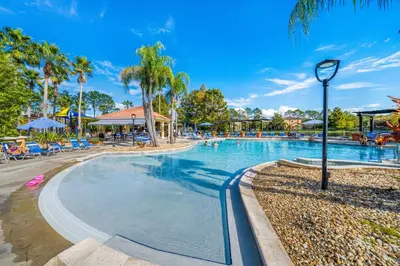 a swimming pool at a resort with palm trees at 4704 Flagler Beach Way in Kissimmee