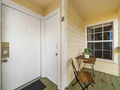 a porch with a table and a chair and a door at 5005 Laguna Bay Cir 18 in Kissimmee