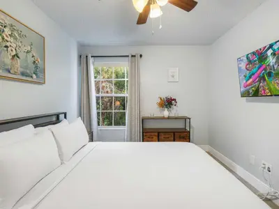 a white bedroom with a bed and a window at 5005 Laguna Bay Cir 18 in Kissimmee