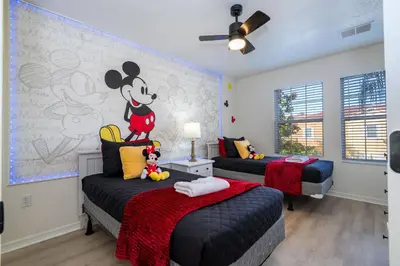 a bedroom with two beds and a mickey mouse mural at Cozy 4 BR close to Disney in Kissimmee