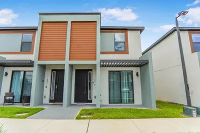 a house with an orange and white at 3 Bedroom 8 Miles from Disney Word in Kissimmee
