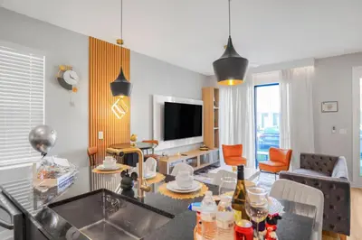 a kitchen and living room with a table and a television at 3 Bedroom 8 Miles from Disney Word in Kissimmee