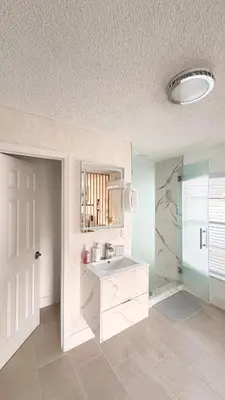 a white bathroom with a sink and a mirror at Hermoso apartaestudio en Orlando in Orlando
