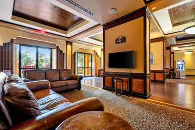 a living room with leather furniture and a flat screen tv at 2BR Fireworks View with Pool & Spa 5 Minutes to Disney in Orlando