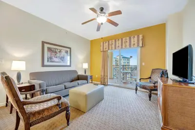a living room with a couch and a tv at 2BR Fireworks View with Pool & Spa 5 Minutes to Disney in Orlando