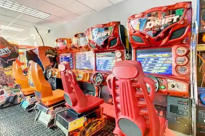 a group of pinball machines in a room at 2BR Fireworks View with Pool & Spa 5 Minutes to Disney in Orlando