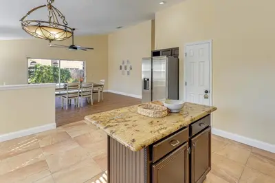 a kitchen with a counter top and a refrigerator at Apopka Family Home with Yard, 13 Mi to Dtwn Orlando in Orlando