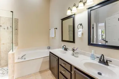 a bathroom with two sinks and a tub and a mirror at Apopka Family Home with Yard, 13 Mi to Dtwn Orlando in Orlando