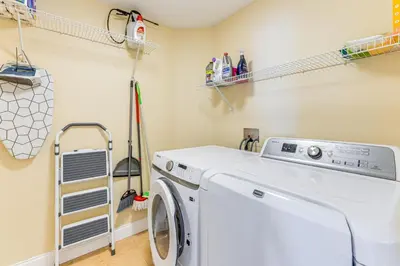 a laundry room with a washing machine and shelves at Apopka Family Home with Yard, 13 Mi to Dtwn Orlando in Orlando