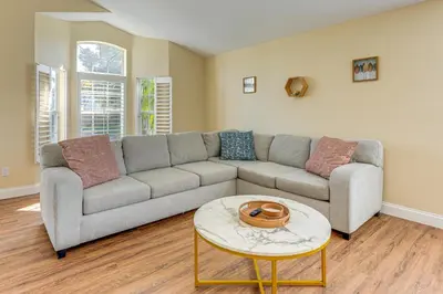 a living room with a couch and a table at Apopka Family Home with Yard, 13 Mi to Dtwn Orlando in Orlando