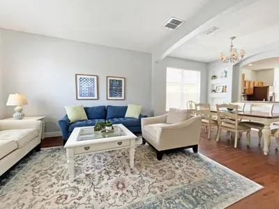 a living room with a blue couch and a table at Endless Summer home in Kissimmee