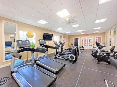 a gym with several treadmills and cardio machines at Oakwater Lookout condo in Orlando