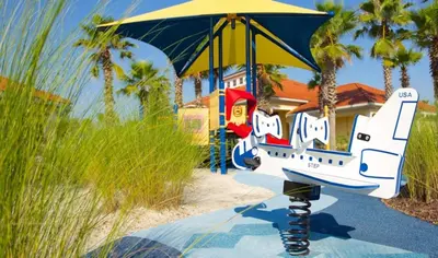 a painting of an umbrella in front of a house at Ormond Retreat townhouse in Kissimmee