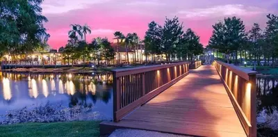 a bridge over a body of water with a sunset at Ormond Retreat townhouse in Kissimmee