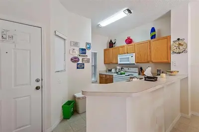 a kitchen with a white counter top in a room at Ormond Retreat townhouse in Kissimmee