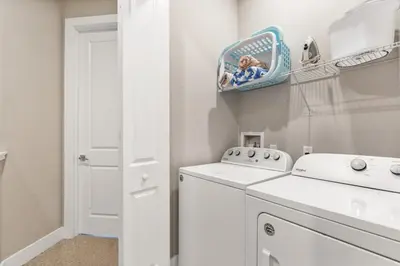 a white laundry room with a washer and dryer at Sunrise Shores townhouse in Orlando