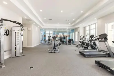 a gym with treadmills and elliptical machines at Sunrise Shores townhouse in Orlando