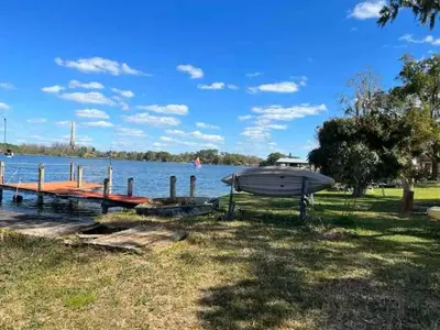 a boat on the shore of a lake at Casa 5Q c/ Piscina e Vista Lago — 3min Universal in Orlando