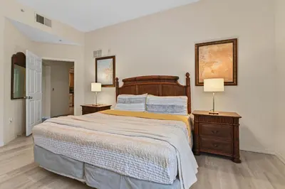 a bedroom with a large bed and two night stands at Serene Gem, close to Disney- HEATEDsaltwaterPOOL in Kissimmee