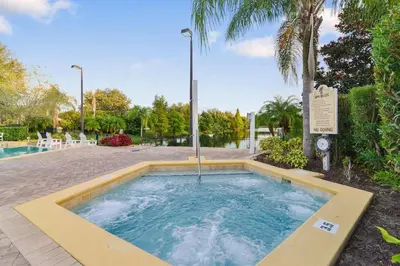 a swimming pool with a hot tub in a yard at Serene Gem, close to Disney- HEATEDsaltwaterPOOL in Kissimmee