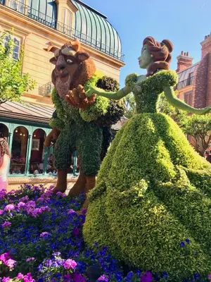 two people dressed up in flowers in a garden at Stylish 3BR Condo Near Disney Pool, Gym & More! in Kissimmee