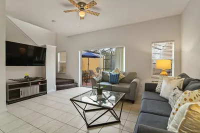 a living room with a couch and a tv at Adventure Awaits! Pool Home just 10 Min to Disney! in Kissimmee