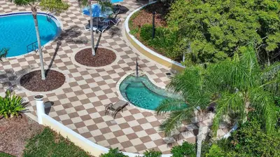 an overhead view of a swimming pool on a checkered floor at Adventure Awaits! Pool Home just 10 Min to Disney! in Kissimmee