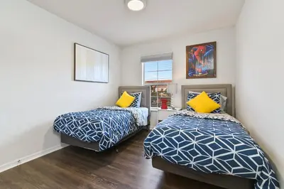 two beds in a room with white walls at Adventure Awaits! Pool Home just 10 Min to Disney! in Kissimmee