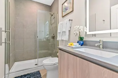 a bathroom with a toilet and a sink and a shower at Unplug in your private oasis-NEW corner Home Pool in Orlando