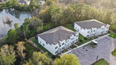 an aerial view of two white buildings next to a lake at Unplug in your private oasis-NEW corner Home Pool in Orlando