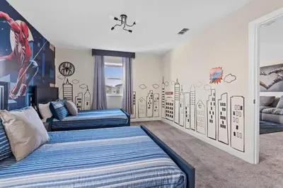 a bedroom with two beds and a mural on the wall at Casa 7Q Storey Lake c/ Piscina, Spa e Game Room in Kissimmee